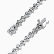 The 925 Sterling Silver Diamond Cluster Tennis Bracelet showcases two rows of round, sparkling diamonds in a repeating cluster pattern, displayed on a white background.