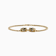 The Signature 14K Yellow Gold Diamond Panther Cuban Chain Bracelet features two opposing panther head clasps with small white and green gemstones, joined by a circular link, shown on a white background.