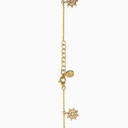 The 14K Yellow Gold Diamond Nautical Charm Bracelet features ship wheels, life rings, sparkling crystals, and a stone-adorned anchor. It includes an adjustable chain and lobster clasp for a perfect fit.