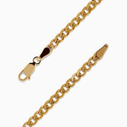 The Signature 14K Yellow Gold Black and White Diamond Panther Bracelet showcases two panther heads with green eyes and diamond accents, joined by black-encrusted circular links.