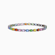The Watercolors 14K White Gold Multi Sapphire and Diamond Tennis Bracelet features a thin band with colorful round sapphires in pink, blue, green, yellow, and orange set in a repeating pattern.