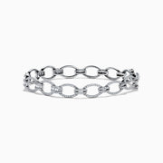 The 14K White Gold Diamond Oval Chain-Link Bracelet showcases a modern and elegant design, featuring alternating smooth and diamond-encrusted oval links, displayed on a white background.