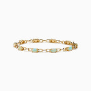 The Aurora 14K Yellow Gold Opal and Diamond Bracelet features evenly spaced round opals in individual links, accented with diamonds for a refined and elegant accessory.