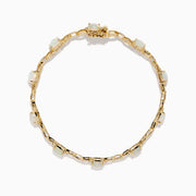 The Aurora 14K Yellow Gold Opal and Diamond Bracelet features evenly spaced round opals in individual links, accented with diamonds for a refined and elegant accessory.