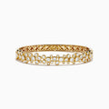 The Lab Grown Round Diamond 2.88ct Bubble Bangle in 14K Yellow Gold features clustered round diamonds and an intricate open lattice inner design.