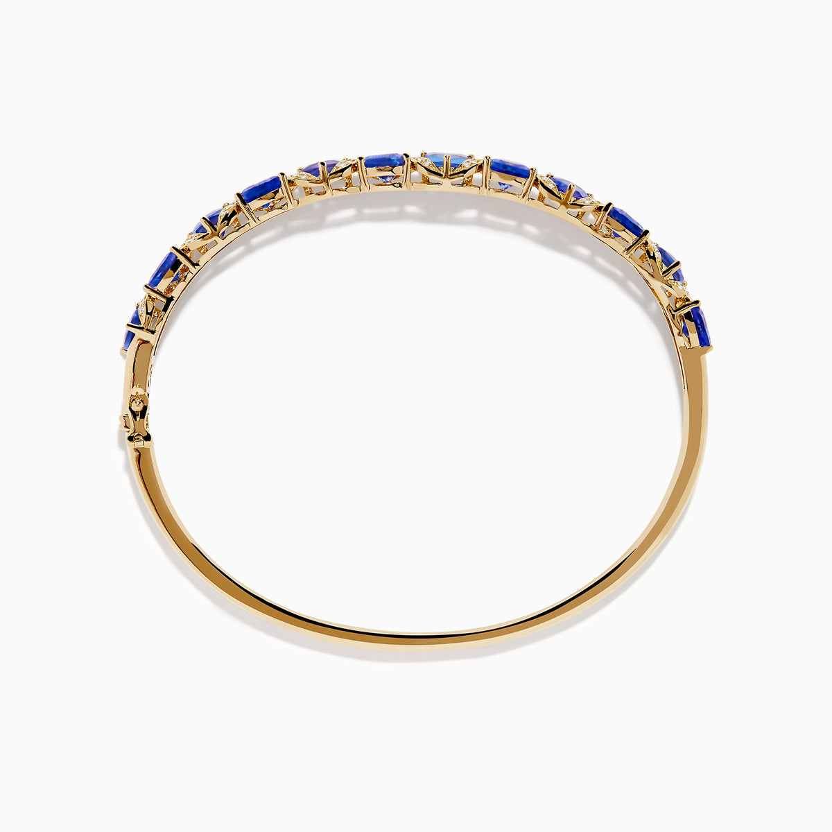 The Nahla 14K Yellow Gold Tanzanite and Diamond Bangle features alternating triangular tanzanite stones and sparkling diamonds in a repeating pattern along the gold band.
