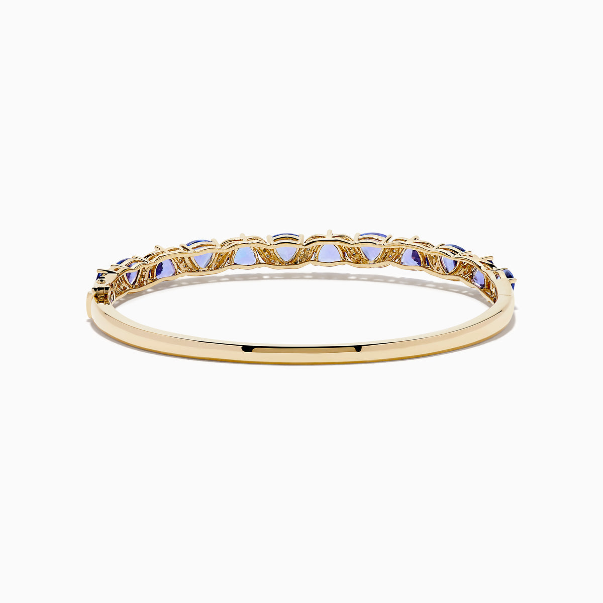 The Nahla 14K Yellow Gold Tanzanite and Diamond Bangle features alternating triangular tanzanite stones and sparkling diamonds in a repeating pattern along the gold band.