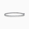 The 14K White Gold Diamond Bangle features two rows of diamonds and a delicate openwork pattern on the inner side.