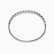 The 14K White Gold Diamond Bangle features two rows of diamonds and a delicate openwork pattern on the inner side.