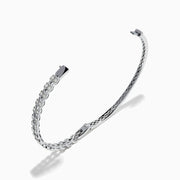 The 14K White Gold Diamond Bangle features two rows of diamonds and a delicate openwork pattern on the inner side.