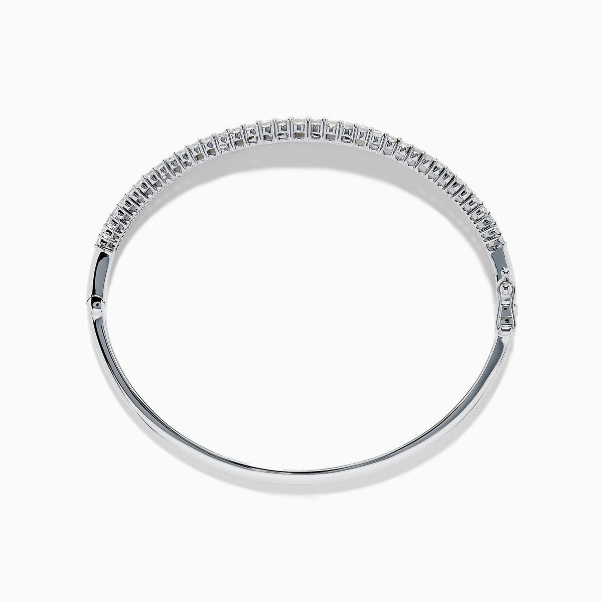 The Classique 14K White Gold Diamond Bangle features two rows of round diamonds and a central row of baguette-cut diamonds, elegantly set against a plain white background.