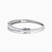 The Classique 14K White Gold Diamond Bangle features two rows of round diamonds and a central row of baguette-cut diamonds, elegantly set against a plain white background.