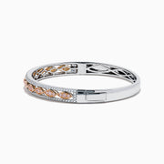 The 14K Two-Tone Gold Pink and White Diamond Bangle features marquise-shaped rose gold accents with pink gemstones, bordered by round white diamonds and an intricate inner openwork design.