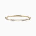 The DOro 14K Yellow Gold Diamond Bangle features a single row of sparkling white diamonds, expertly crafted in radiant yellow gold and elegantly displayed against a white background.