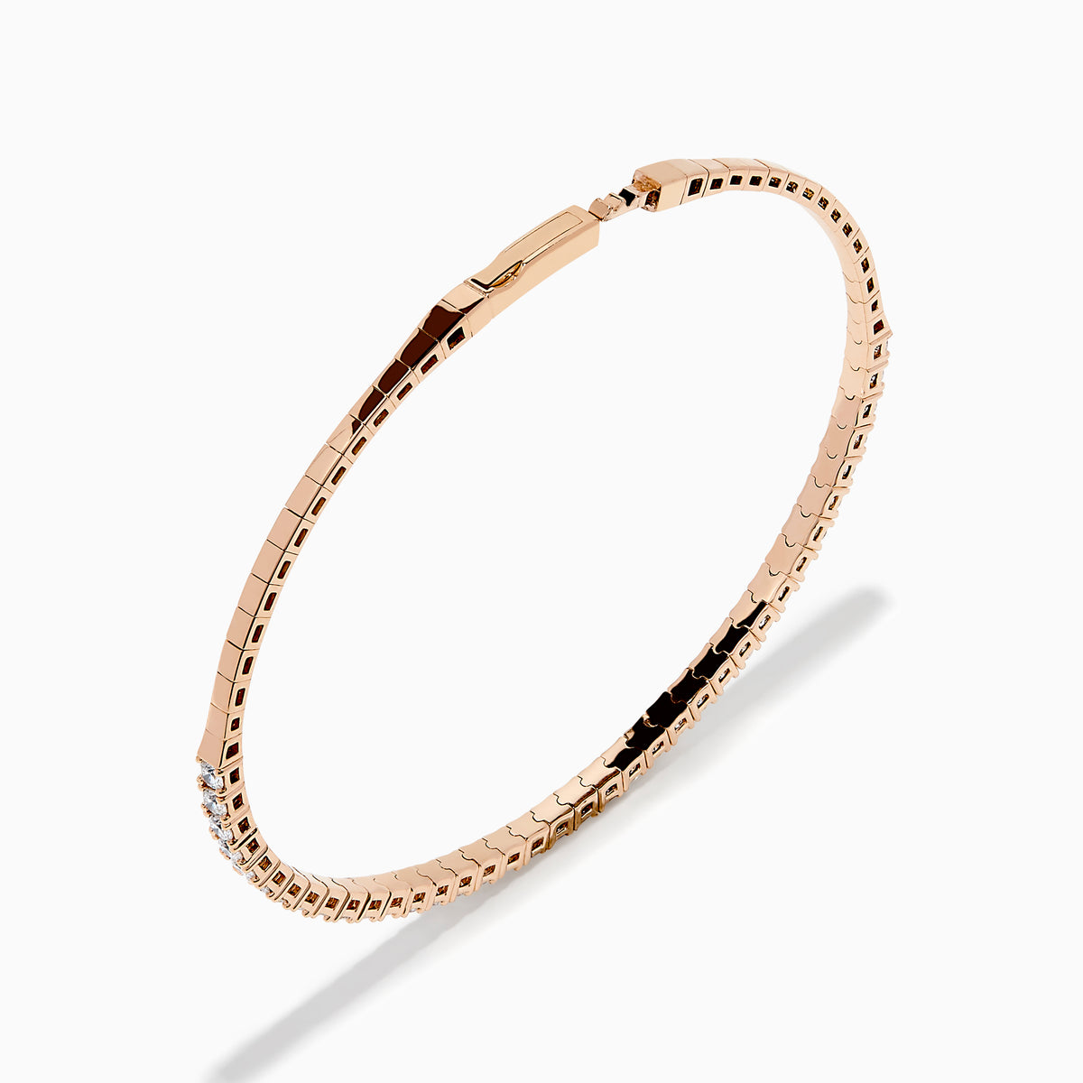 The Pave Rose 14K Rose Gold Diamond Bangle features a slim band adorned with a single row of sparkling white diamonds, set all around its circumference and shown on a white background.
