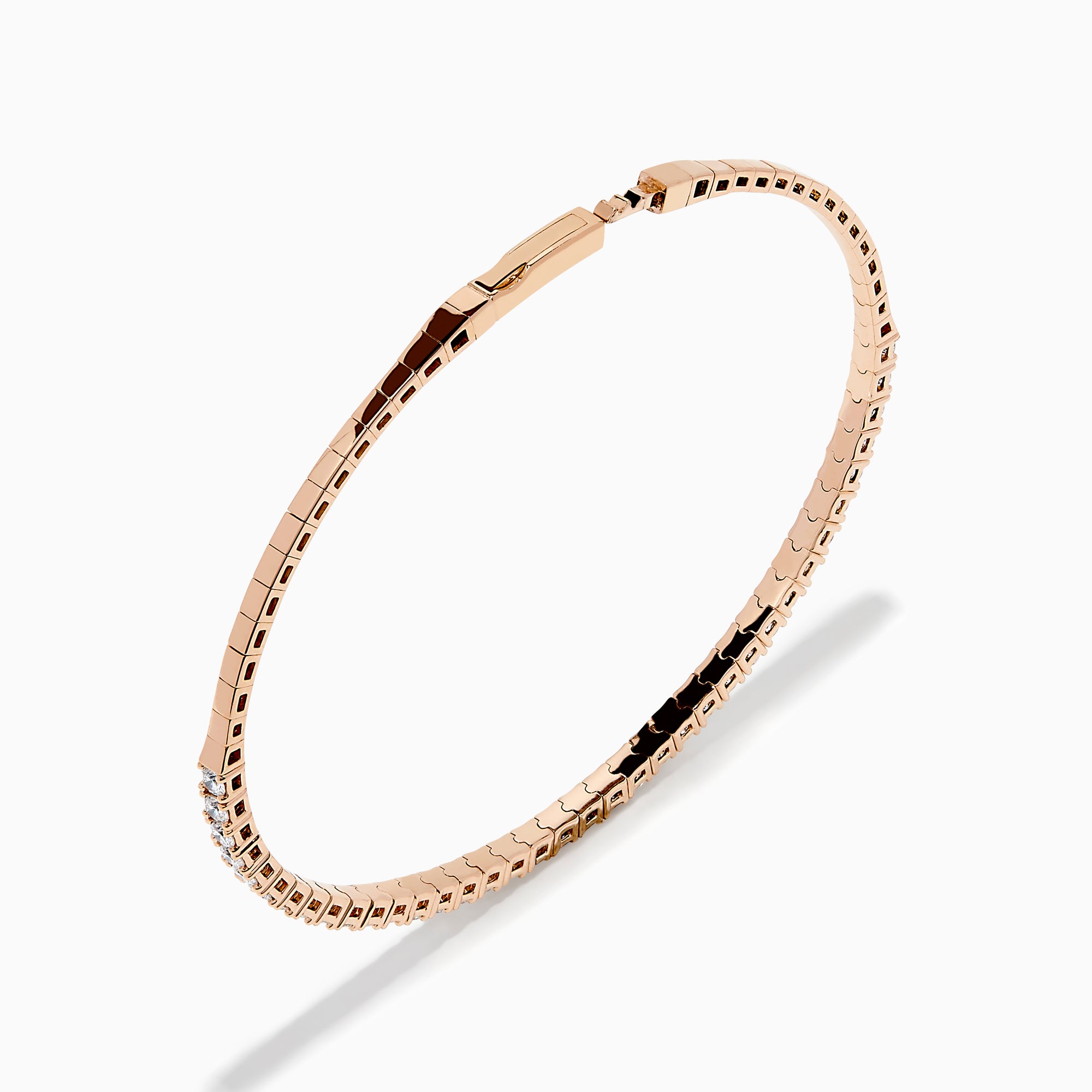 The Pave Rose 14K Rose Gold Diamond Bangle features a slim band adorned with a single row of sparkling white diamonds, set all around its circumference and shown on a white background.