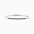 The Caviar 14K White Gold Black Diamond Bangle is a slim silver bracelet adorned with a row of small black diamonds, reminiscent of caviar, displayed on a white background.