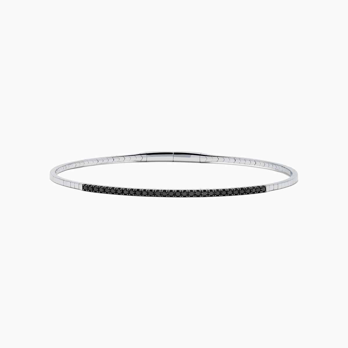 The Caviar 14K White Gold Black Diamond Bangle is a slim silver bracelet adorned with a row of small black diamonds, reminiscent of caviar, displayed on a white background.