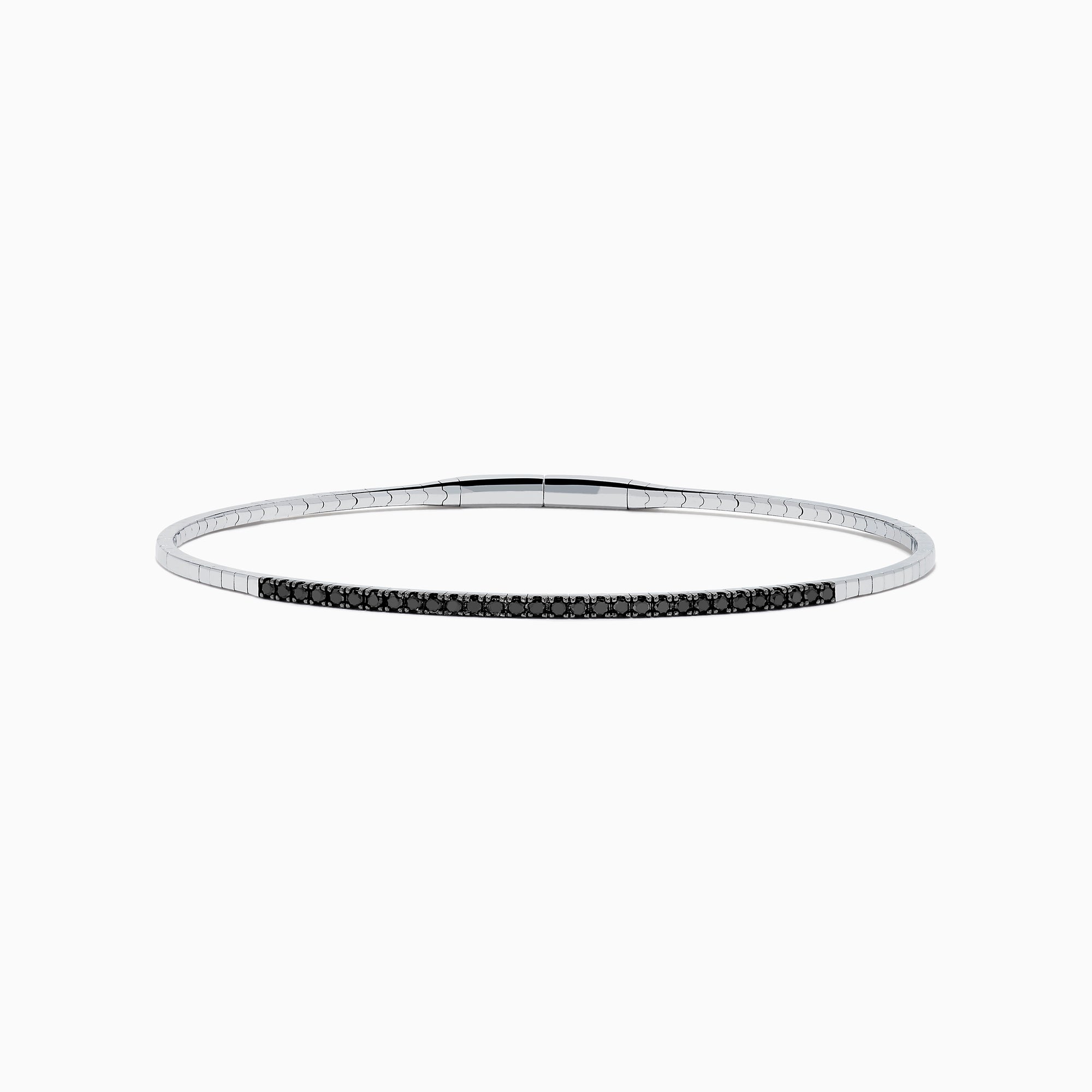 The Caviar 14K White Gold Black Diamond Bangle is a slim silver bracelet adorned with a row of small black diamonds, reminiscent of caviar, displayed on a white background.