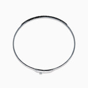 The Caviar 14K White Gold Black Diamond Bangle is a slim silver bracelet adorned with a row of small black diamonds, reminiscent of caviar, displayed on a white background.