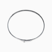 The Classique 14K White Gold Flexible Diamond Bangle features a sleek, minimalist design with a polished finish and a thin row of sparkling diamonds along the top half for effortless elegance.