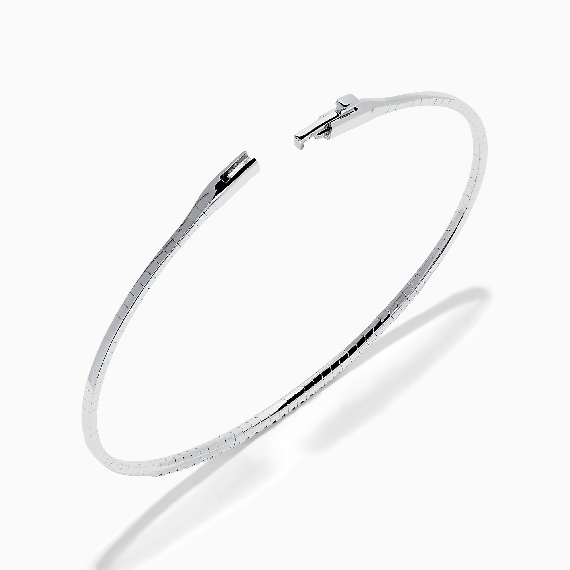 The Classique 14K White Gold Flexible Diamond Bangle features a sleek, minimalist design with a polished finish and a thin row of sparkling diamonds along the top half for effortless elegance.