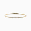 The D'Oro 14K Yellow Gold Pave Diamond Flexible Bangle features a slim, flexible design with a row of sparkling pave diamonds along the top half, shown against a plain white background.