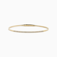The D'Oro 14K Yellow Gold Pave Diamond Flexible Bangle features a slim, flexible design with a row of sparkling pave diamonds along the top half, shown against a plain white background.