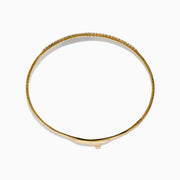 The D'Oro 14K Yellow Gold Pave Diamond Flexible Bangle features a slim, flexible design with a row of sparkling pave diamonds along the top half, shown against a plain white background.