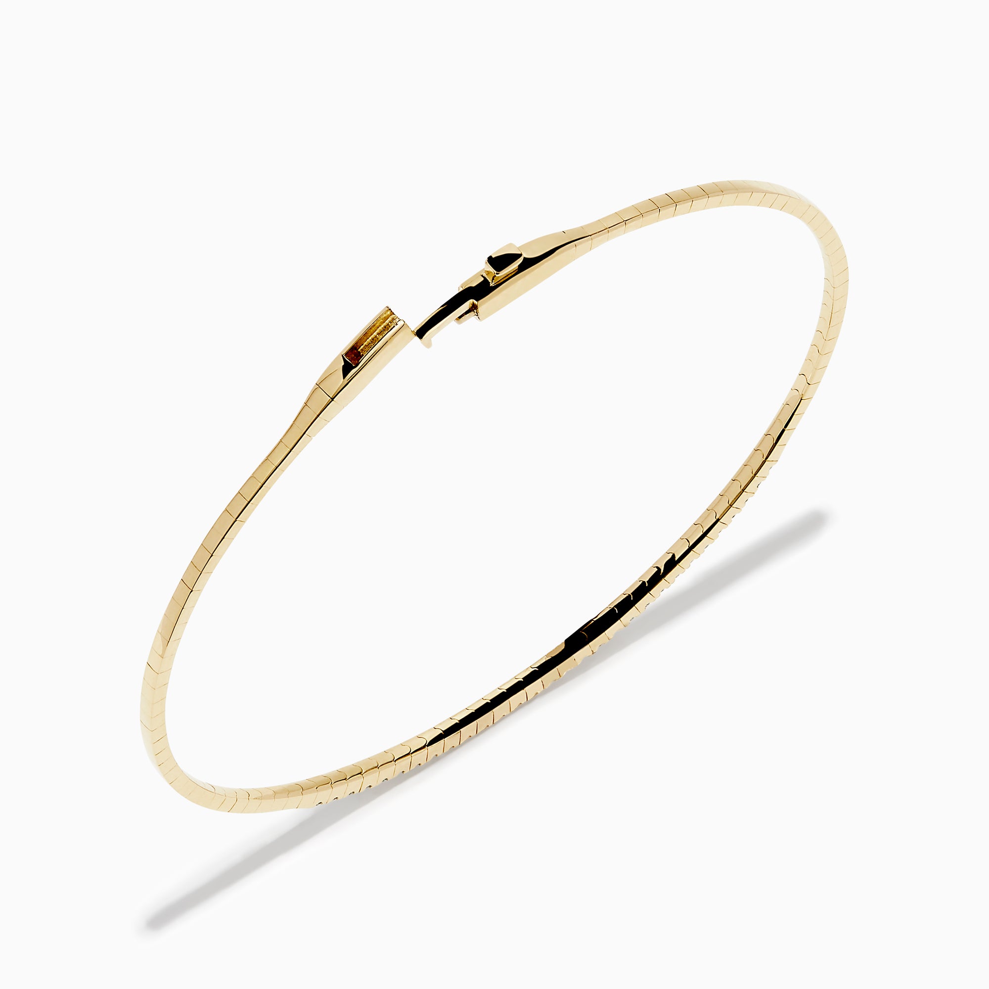 The D'Oro 14K Yellow Gold Pave Diamond Flexible Bangle features a slim, flexible design with a row of sparkling pave diamonds along the top half, shown against a plain white background.