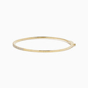 The D'Oro 14K Yellow Gold Pave Diamond Flexible Bangle features a slim, flexible design with a row of sparkling pave diamonds along the top half, shown against a plain white background.