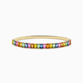 The Watercolor 14k Yellow Gold Emerald Cut Multi Sapphire Bangle features multicolored gemstones in a continuous row, creating a vibrant look.