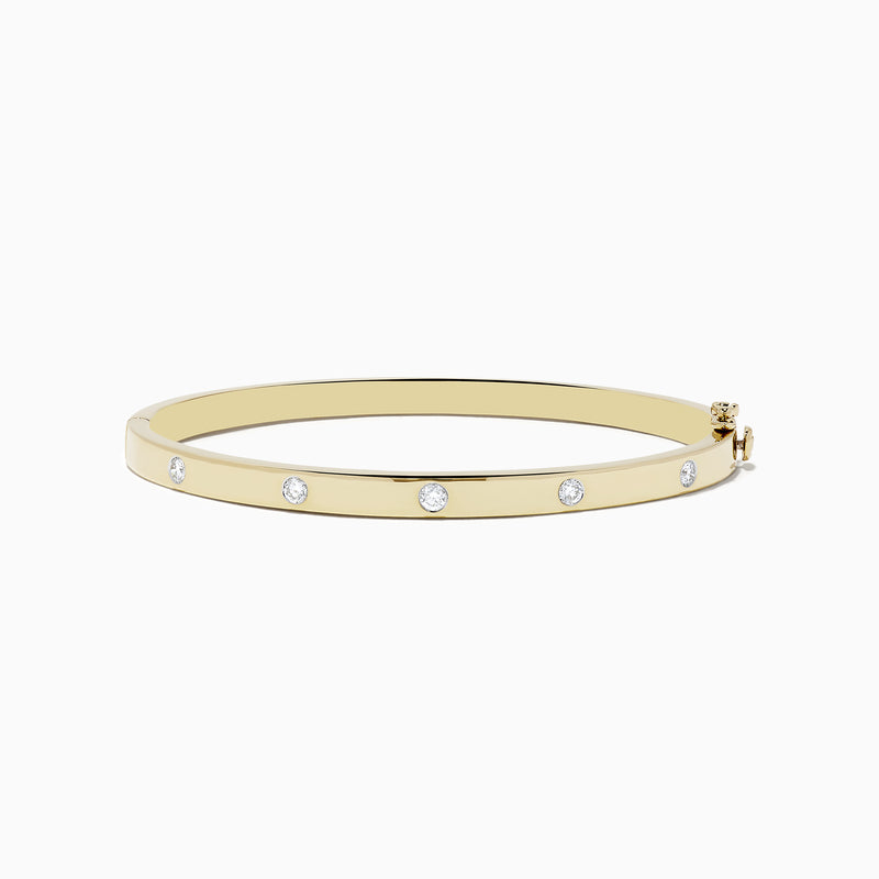 The DOro 14k Yellow Gold Bezel Set Diamond Bangle 0.35 TCW showcases evenly spaced round bezel set diamonds, elegantly displayed on a plain white background.