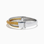 The 14K Two Tone Gold Yellow and White Diamond Pave Crossover Bangle features elegant overlapping rows of yellow and white diamonds in a sparkling, layered design.