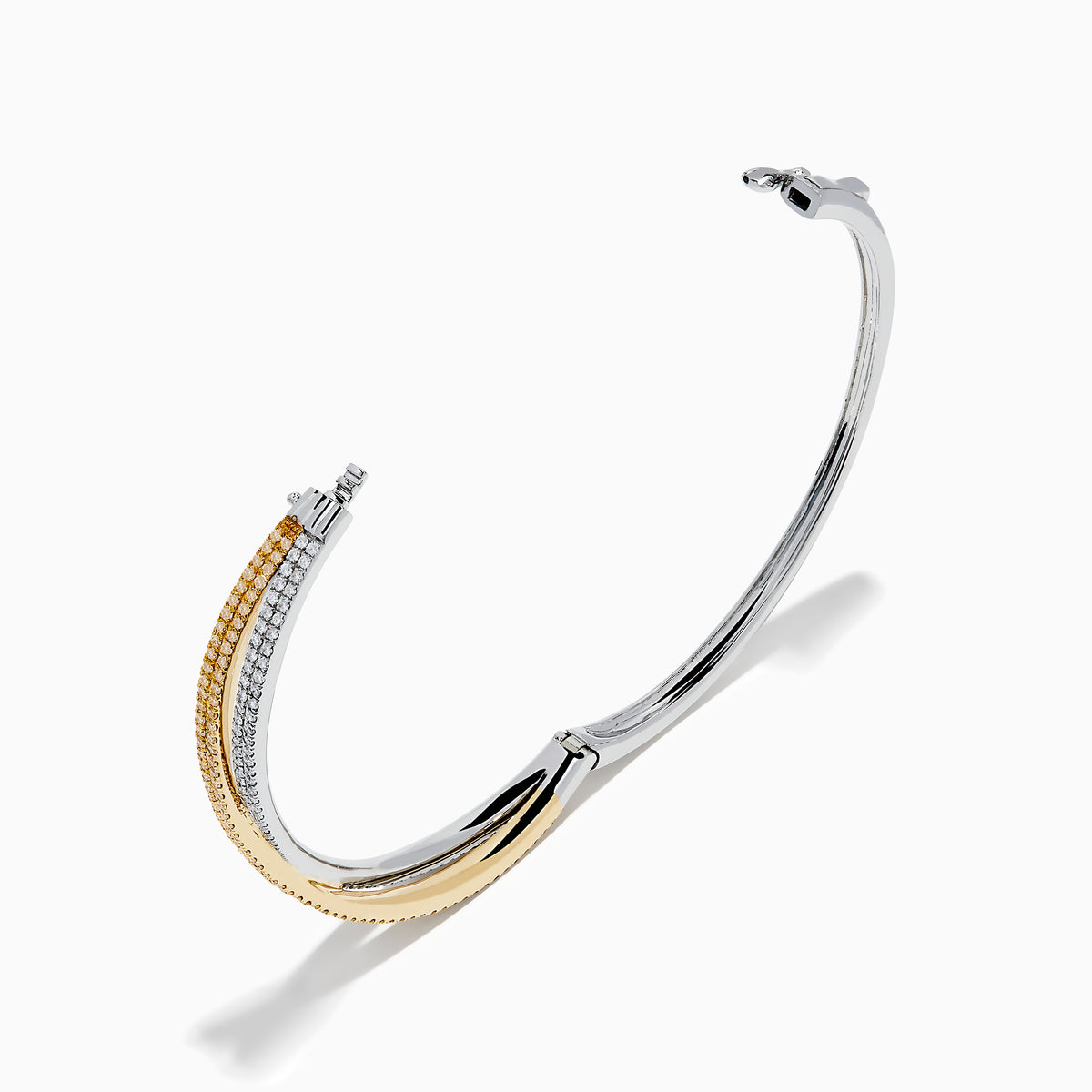 The Canare 14K Two Tone White and Yellow Diamond Criss Cross Bangle features intertwined bands of white and yellow gold, each adorned with sparkling diamonds for a dazzling effect.