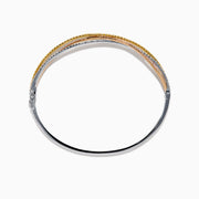 The 18K 3-Tone Gold White, Yellow and Pink Diamond Criss Cross Bangle features three intertwined rows of white, yellow, and pink diamonds set in an elegant, polished design.