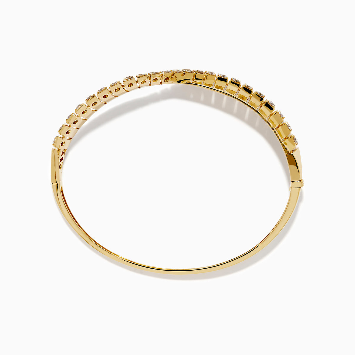 The 14K Yellow Gold Diamond Sculptural Twist Bangle features a wavy twist design with sparkling white diamonds set along the curve on a sleek gold background.
