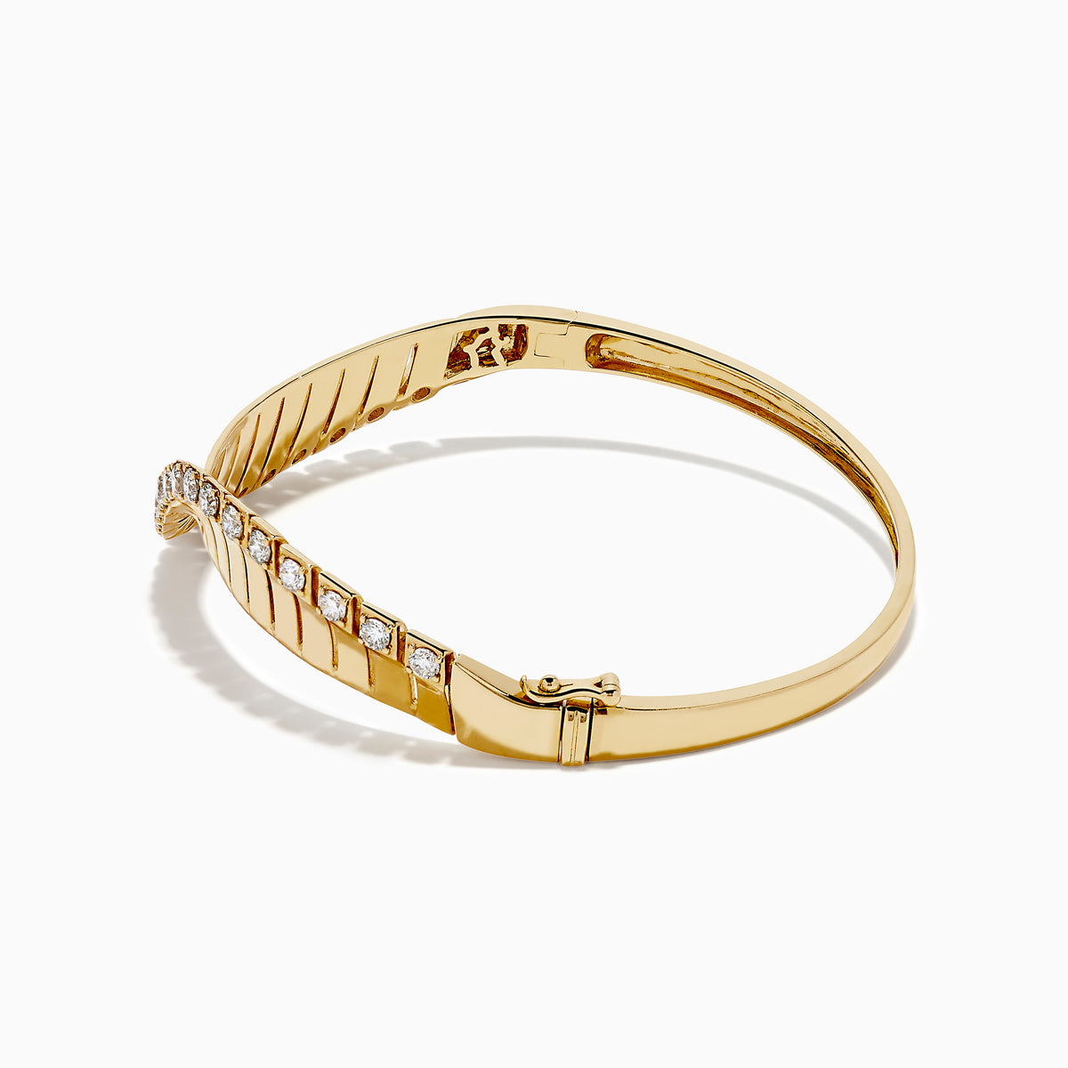 The 14K Yellow Gold Diamond Sculptural Twist Bangle features a wavy twist design with sparkling white diamonds set along the curve on a sleek gold background.