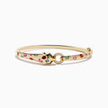 The Signature 14K Gold Multi Sapphire and Diamond Panther Bangle features a panther head clasp adorned with multi sapphire gemstones and a circular diamond-set ring.