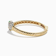 The 14K Yellow Gold White and Green Enamel Snake Bypass Bangle features a white and gold scale pattern on the head and tail, highlighted with green enamel eyes.