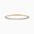 The 14K Two Tone Gold Diamond Station Flex Bangle features round white diamonds set along the top half, shown on a white background.