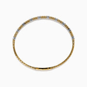 The 14K Two Tone Gold Diamond Station Flex Bangle features round white diamonds set along the top half, shown on a white background.