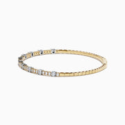 The 14K Two Tone Gold Diamond Station Flex Bangle features round white diamonds set along the top half, shown on a white background.