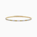 The 14K Two Tone Gold Diamond Flexible Bangle features alternating sections of small round white diamonds and plain gold, offering timeless elegance and a hint of sparkle. Shown on a simple white background.