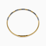 The 14K Two Tone Gold Diamond Flexible Bangle features alternating sections of small round white diamonds and plain gold, offering timeless elegance and a hint of sparkle. Shown on a simple white background.