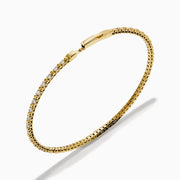The 14K Yellow Gold Diamond Flex Bangle features a single row of sparkling white diamonds and a secure clasp, presented against a white background.