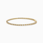 The 14K Yellow Gold Diamond Flex Bangle features a single row of sparkling white diamonds and a secure clasp, presented against a white background.