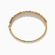 The Watercolors 14K Yellow Gold Multi Sapphire Bangle features marquise-cut sapphires in blue, green, pink, orange, and yellow, set in a leaf-inspired pattern, evoking the look of vibrant watercolors.