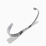 The 925 Sterling Silver Diamond Accented Bangle features a smooth, slightly curved center, two rows of sparkling stones along the edges, and a decorative lattice pattern inside.