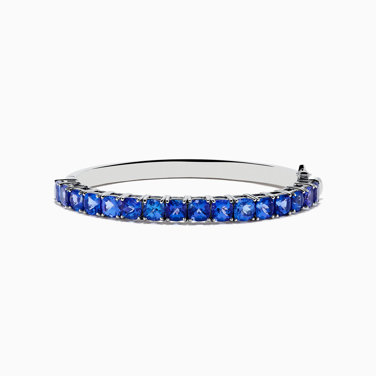 The Nahla Siri 925 Silver Tanzanite Bangle features a polished band set with sparkling blue gemstones, displayed on a white background.
